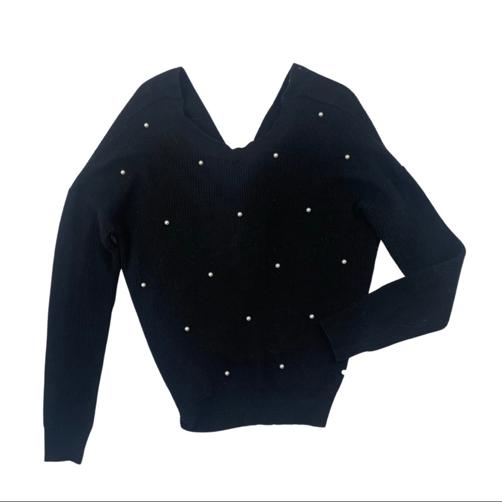 Black sweater with pearl accents.